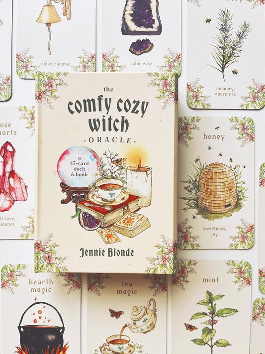 The Comfy Cozy Witch Oracle by Jennie Blonde featuring cosy witchcraft-inspired artwork, comforting oracle cards, and a companion guidebook.