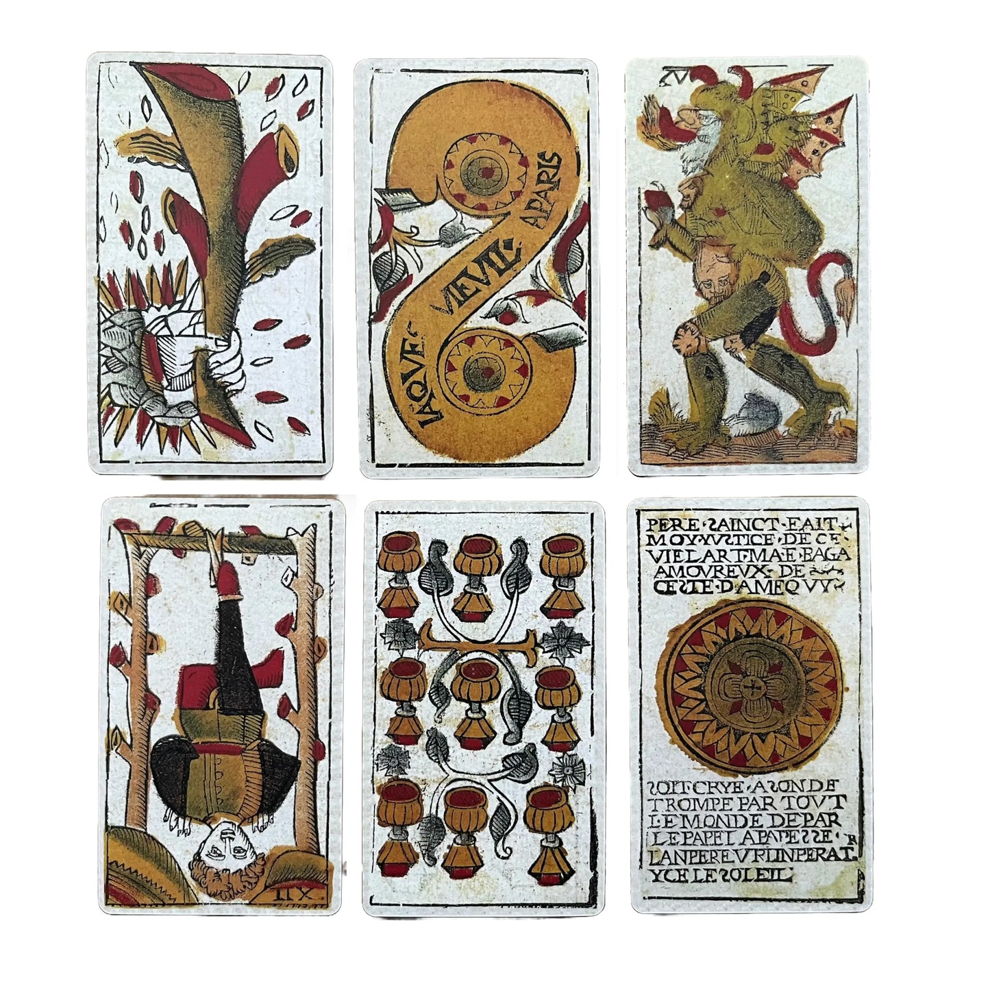 Set of six vintage playing cards with intricate designs on a white background