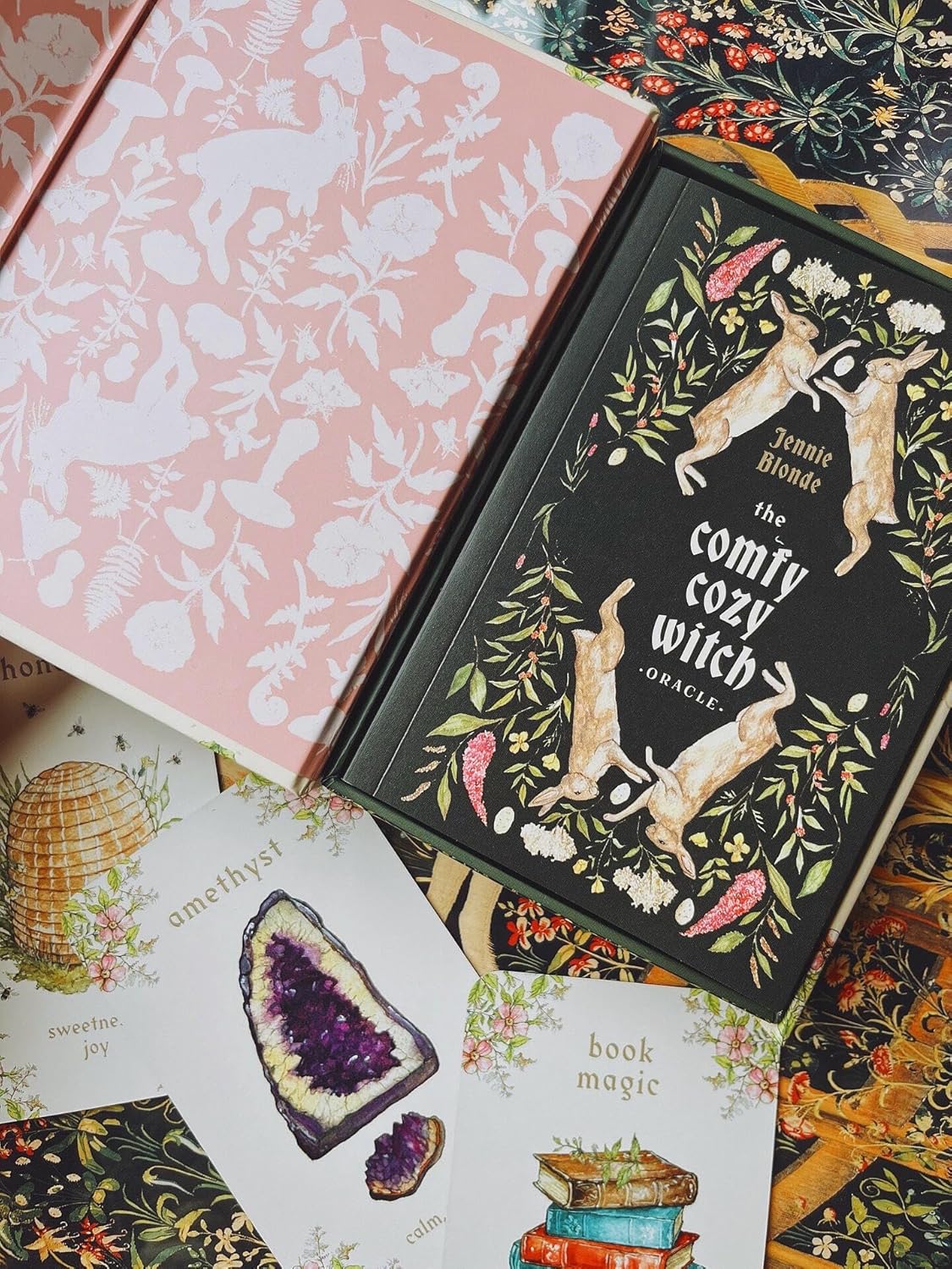 The Comfy Cozy Witch Oracle by Jennie Blonde featuring cosy witchcraft-inspired artwork, comforting oracle cards, and a companion guidebook.