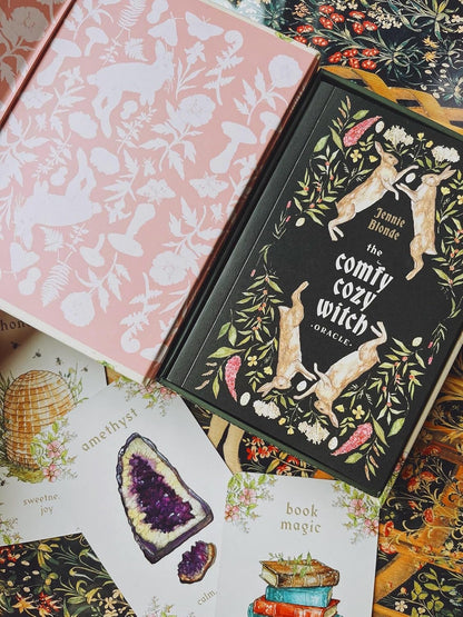 The Comfy Cozy Witch Oracle by Jennie Blonde featuring cosy witchcraft-inspired artwork, comforting oracle cards, and a companion guidebook.