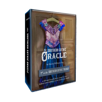 Box for 'The Southern Gothic Oracle' with a dress on a hanger against a wooden background