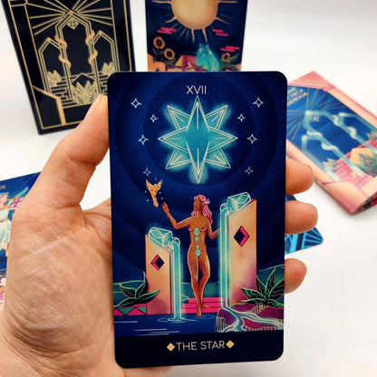 Tarot card titled 'The Star' held by a hand with other tarot cards in the background.