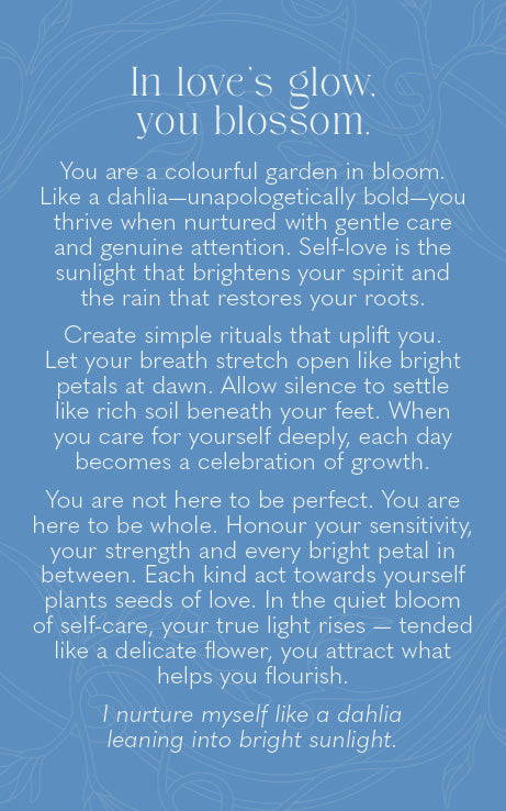 A square blue card or print with white text reading a self-help or affirmation quote about dahlia flowers and self-care, set against a matching blue patterned background.
