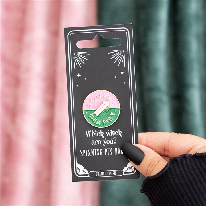 Which Witch Are You spinning enamel pin badge with pink, green and white design and interactive rotating arrow.