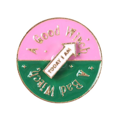 Which Witch Are You spinning enamel pin badge with pink, green and white design and interactive rotating arrow.