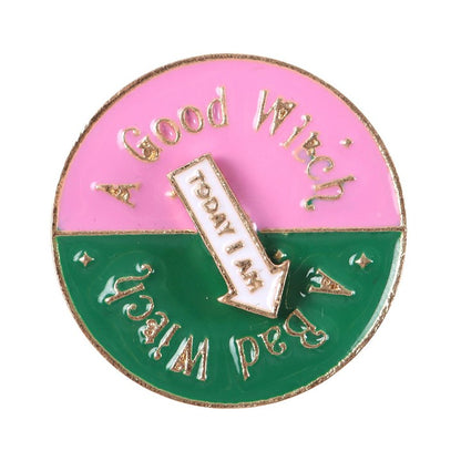 Which Witch Are You spinning enamel pin badge with pink, green and white design and interactive rotating arrow.