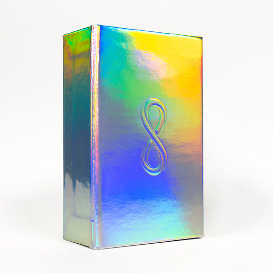 Tarot of the Holy Spectrum Infinity Edition Holographic Mirror by Chase Voorhees, featuring colourful tarot cards, reflective holographic backs and edges, and a mirrored magnetic box.