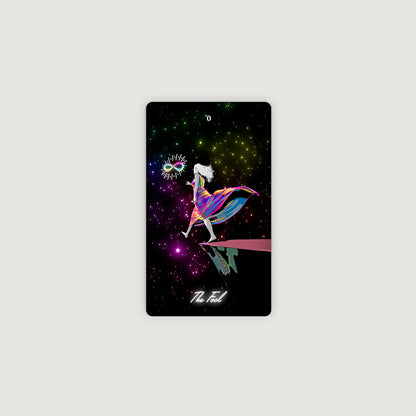 A tarot card titled 'The Fool' featuring a colorful, stylized illustration of a figure in a mask against a starry cosmic background, displayed on a light gray background. Tarot of the Holy Spectrum Infinity Edition Holographic Mirror by Chase Voorhees, featuring colourful tarot cards, reflective holographic backs and edges, and a mirrored magnetic box.