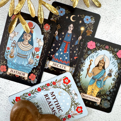 Set of tarot cards featuring deities with decorative elements on a textured surface.