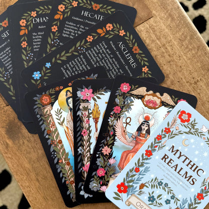 Mythic realms oracle deck and goddess cards on a wooden table 