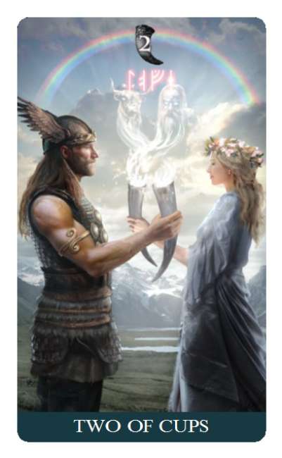 Tarot card featuring two figures under a rainbow with 'Two of Cups' text