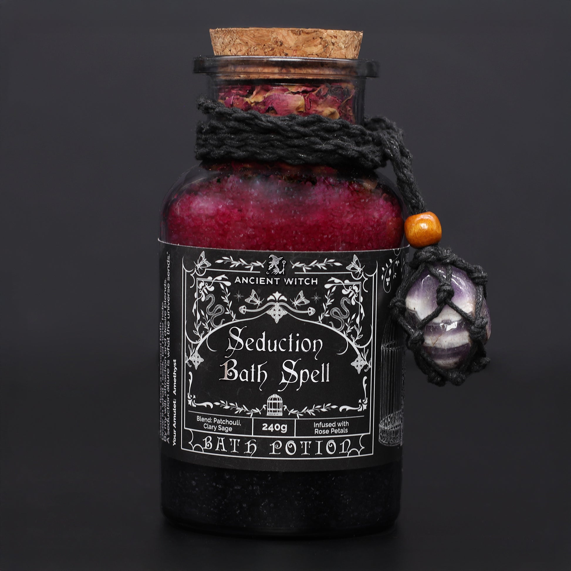 Bottle of 'Seduction Bath Spell' bath potion with decorative elements on a dark background