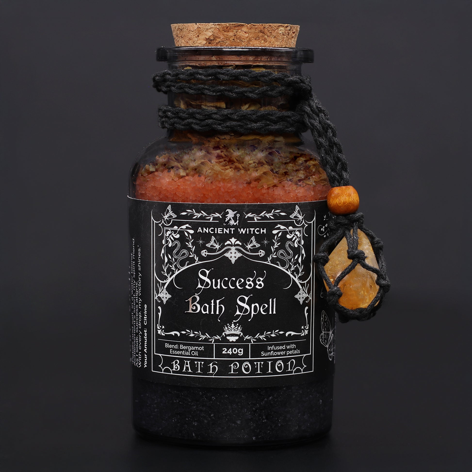 Bottle labeled 'Success Bath Spell' with decorative elements on a dark background
