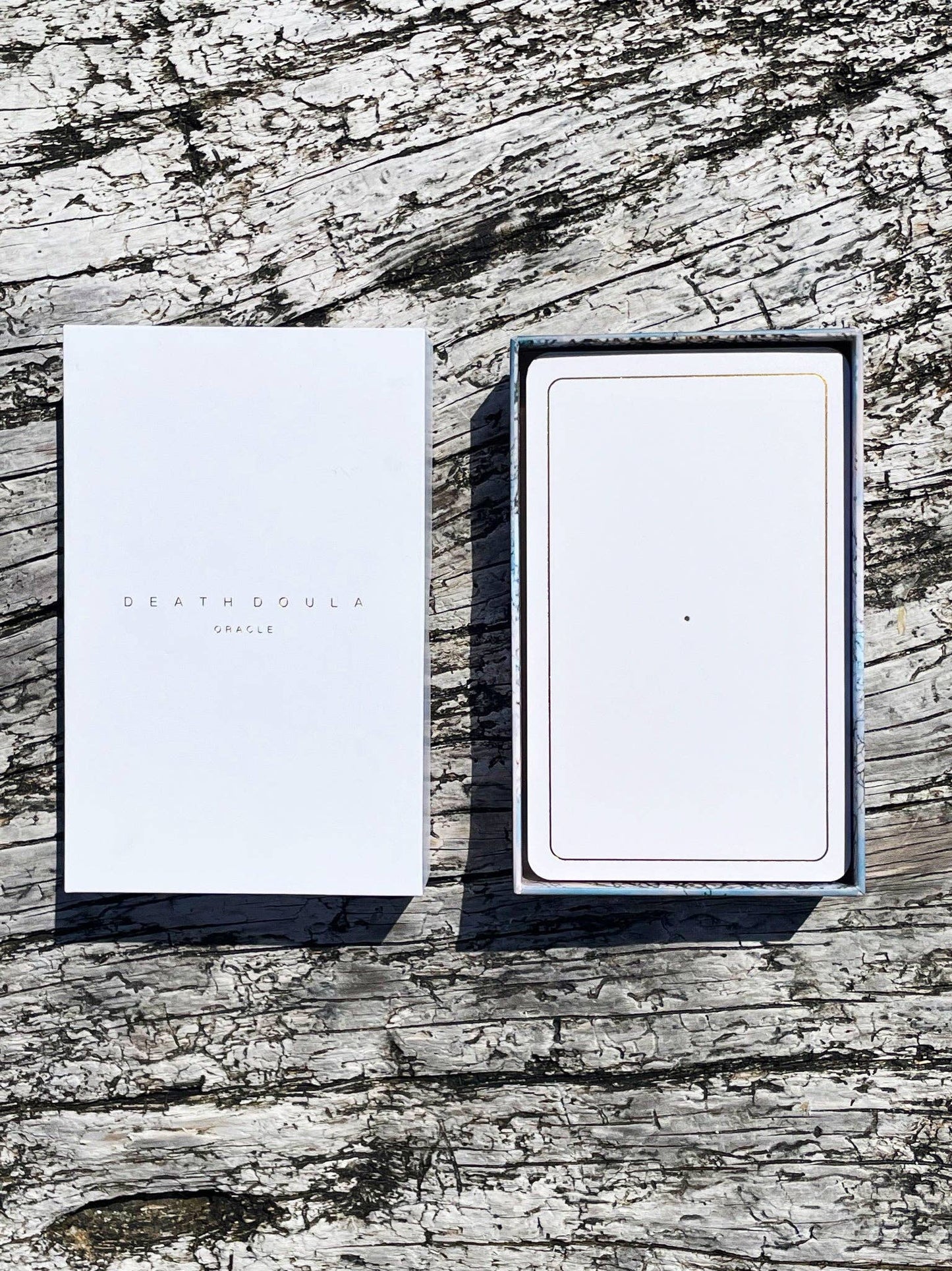 Death Doula Oracle Cards featuring original analogue 35mm photography with double exposure imagery, gold gilded edges and a guidebook for spiritual transformation and healing.