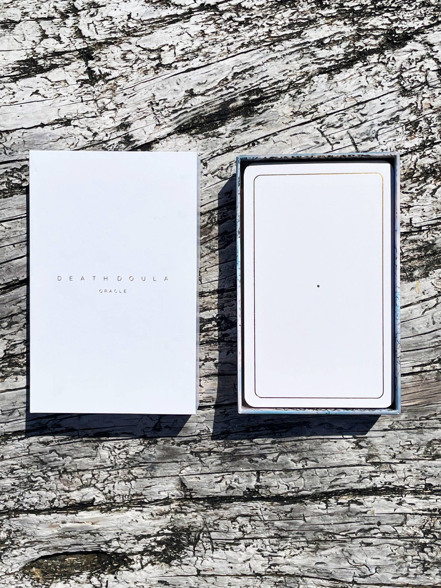 Death Doula Oracle Cards featuring original analogue 35mm photography with double exposure imagery, gold gilded edges and a guidebook for spiritual transformation and healing.
