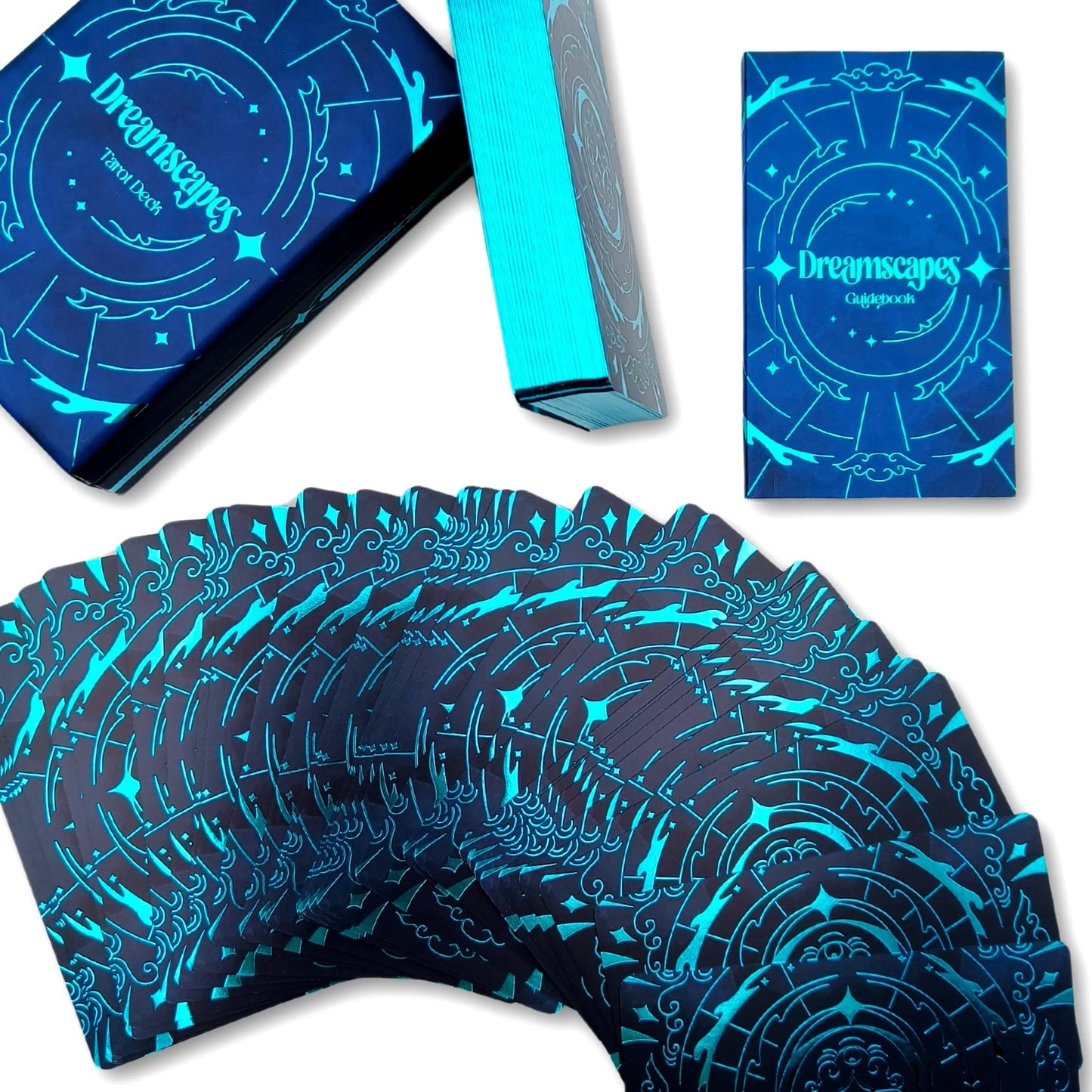 Blue and black playing cards with 'Dreamscapes' branding on packaging
