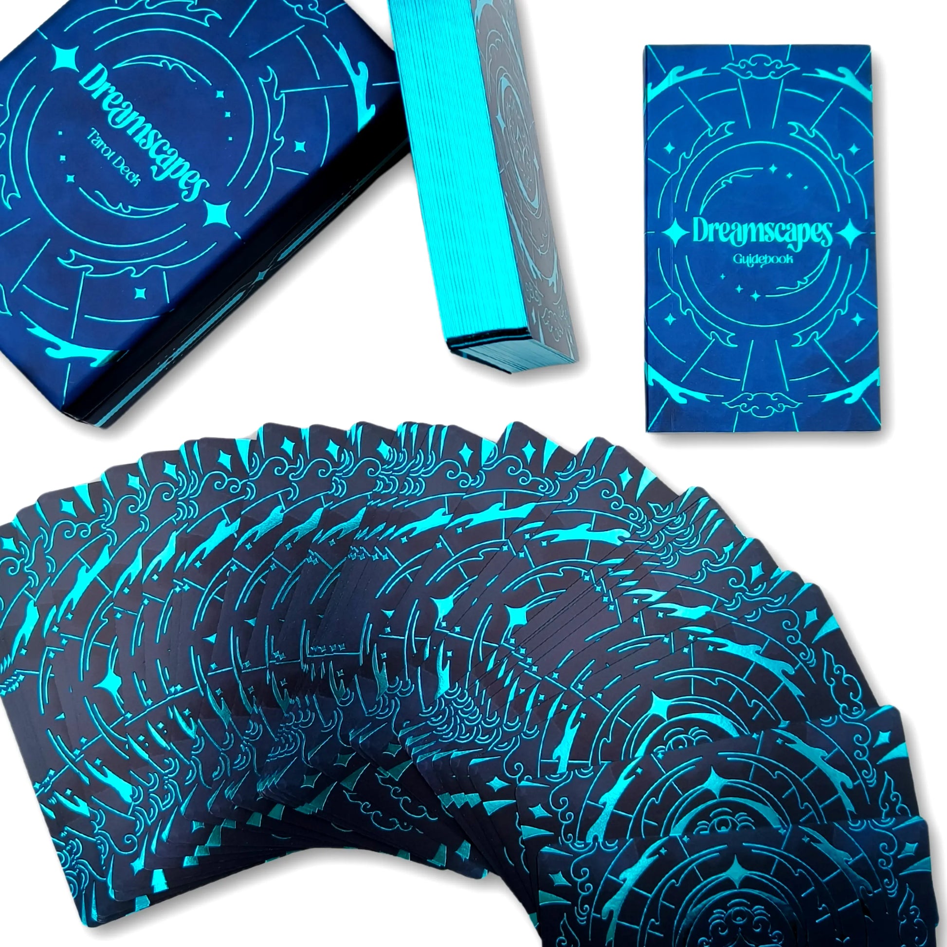 Blue and black playing cards with 'Dreamscapes' branding on packaging