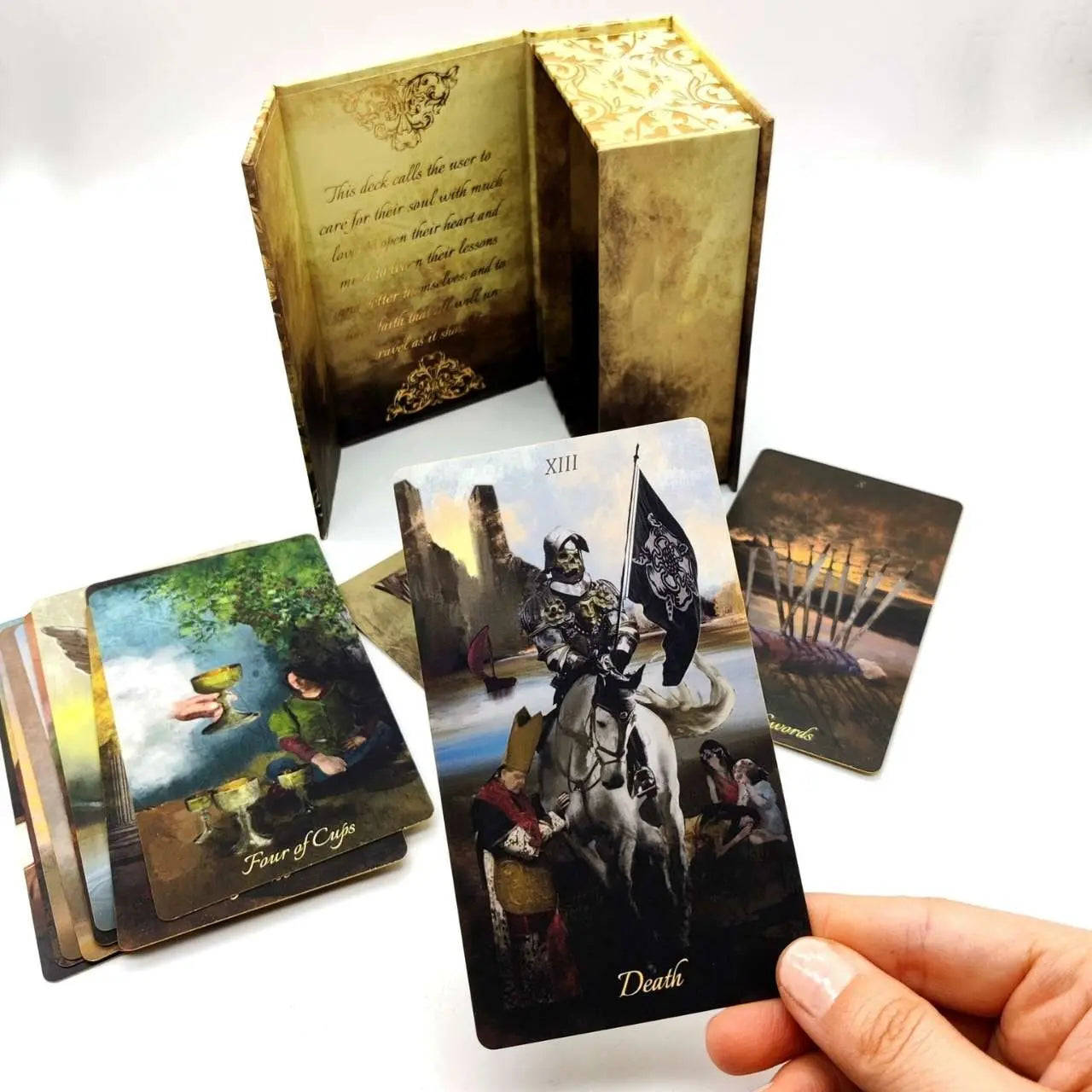 Tarot cards with detailed artwork and a decorative box on a white background Baroque tarot by La Muci 