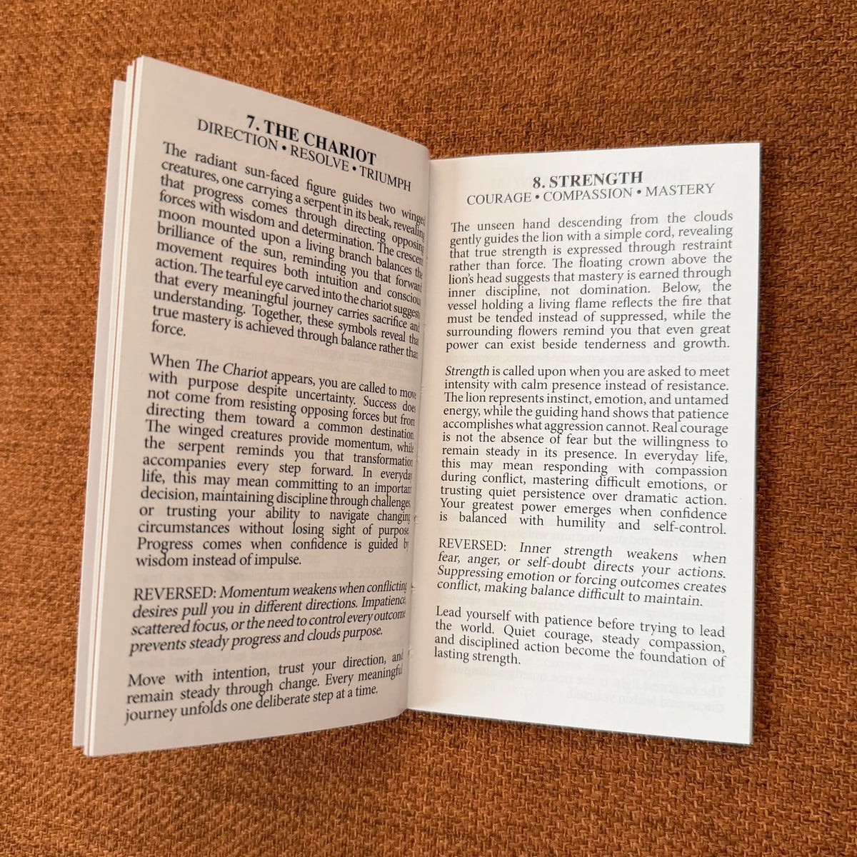 An open book showing two printed pages with text about yoga and meditation, photographed on a textured brown fabric background.