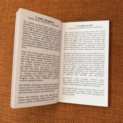 An open book showing two printed pages with text about yoga and meditation, photographed on a textured brown fabric background.