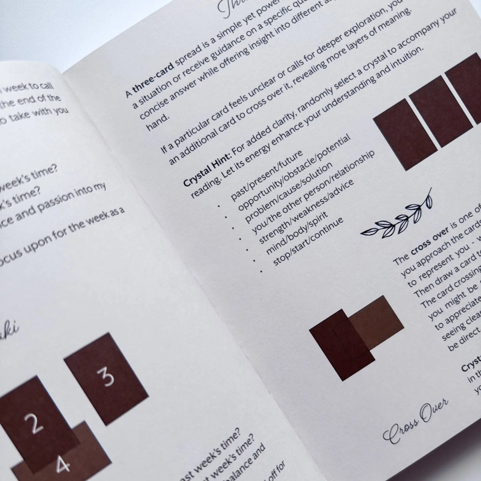 Open book with crystal card reading instructions and color swatches on a white background Meraki workbook for tarot and crystal work 