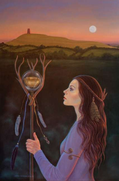 Avalon Visions Oracle deck by Cheryl Yambrach Rose featuring Celtic mystical artwork inspired by Avalon and Arthurian legend. Woman holding a staff with a spherical object, set against a landscape with a hill and moon.