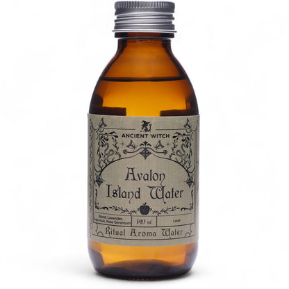 Amber bottle of Avalon Island Water with a silver cap on a white background