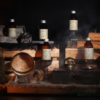 Ritual water bottles with labels on a wooden surface with a dark background