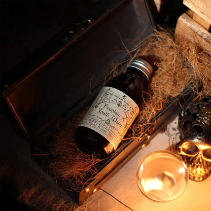 Bottle labeled 'Fountain of Youth Water' in a decorative setting with hay and a skull.