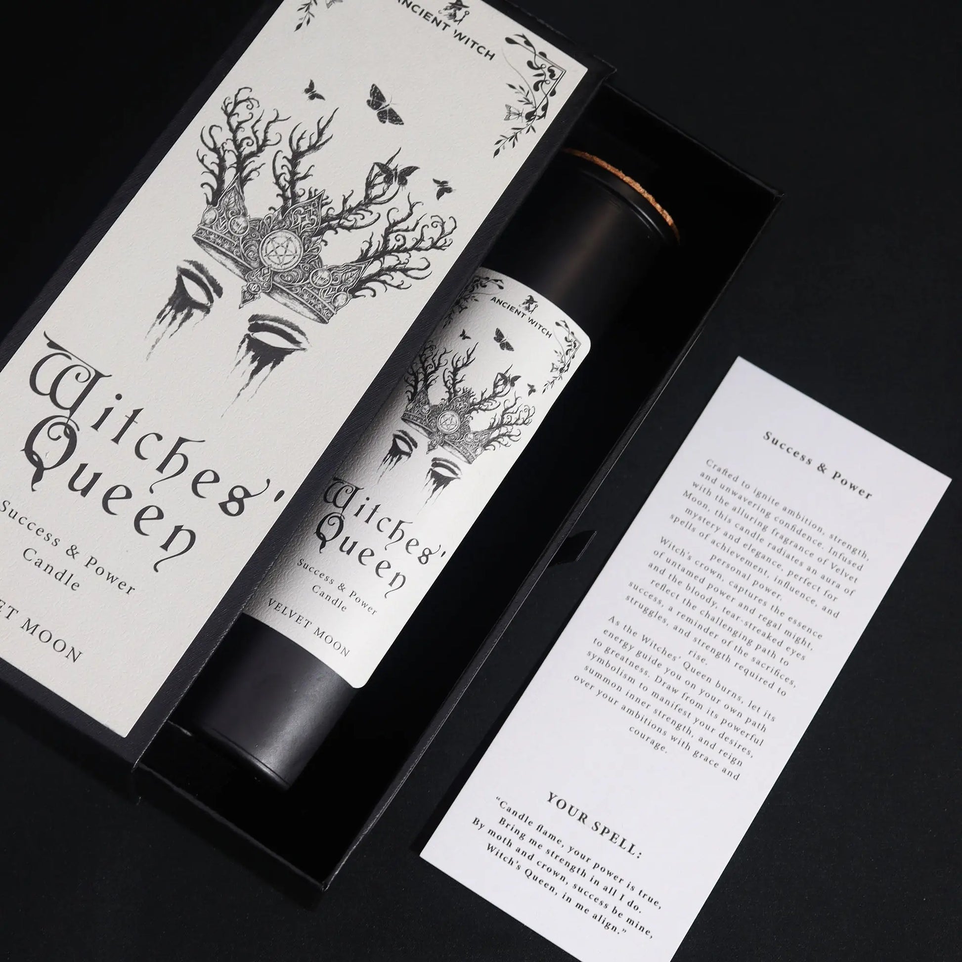 Witches' Queen candle packaging with black and white design on a dark background