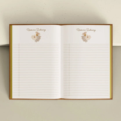 Open notebook with lined pages and decorative elements on a neutral background Grimoire Bouchette and Co Oneness Emporium