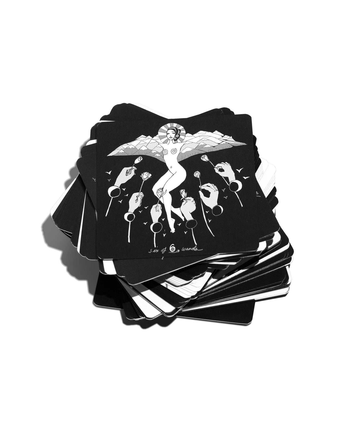 Stack of black tarot cards with white illustrations on a white background Dark Days Tarot by Wren McMurdo Brignac featuring square black-and-white tarot cards inspired by the lunar cycle with a 180-page guidebook and collector's box.