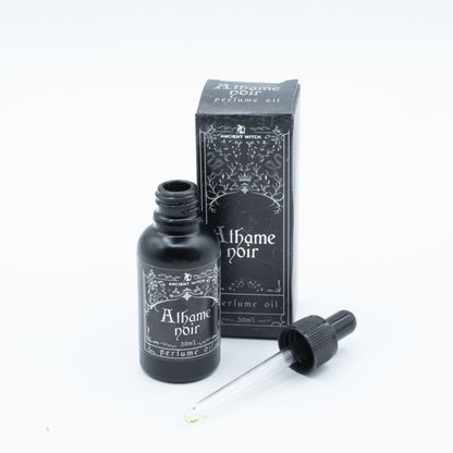 Perfume oil bottle with dropper and packaging on a white background