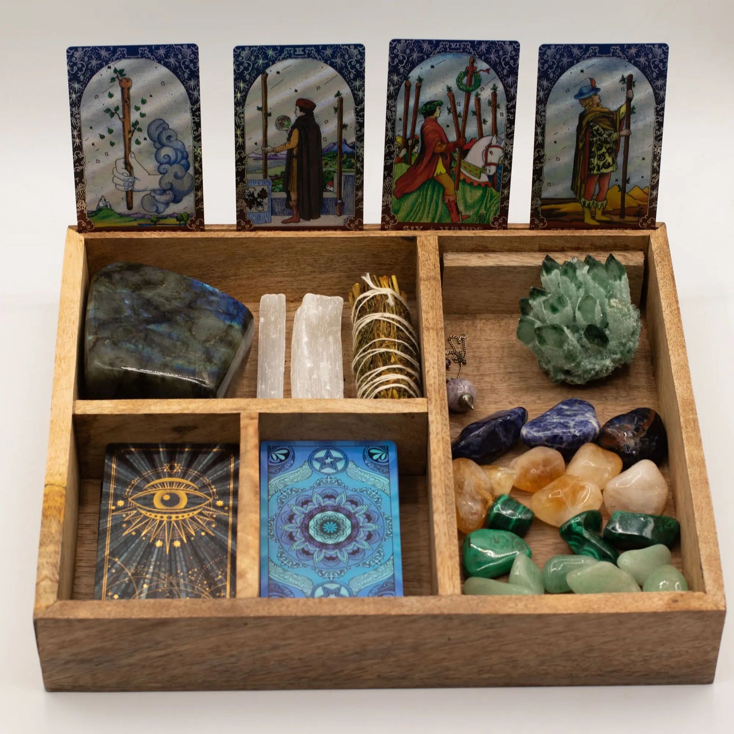 Wooden box with tarot cards and crystals on a white background