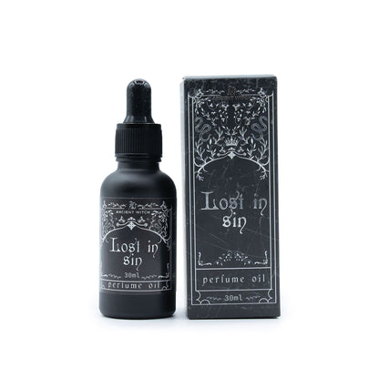 Perfume oil bottle and packaging with 'Lost in Sin' text on a white background