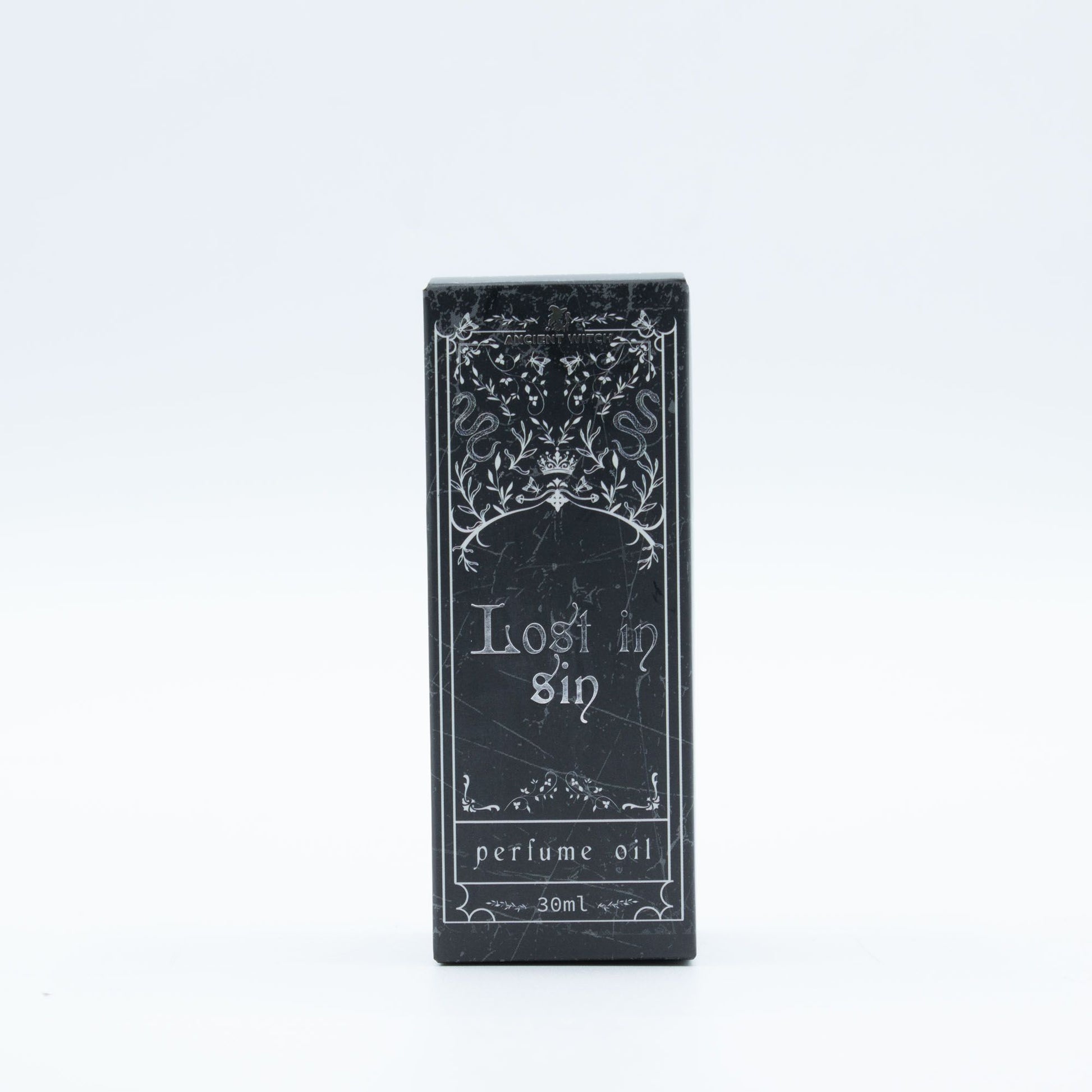 Black packaging of 'Lost in Sin' perfume oil on a white background