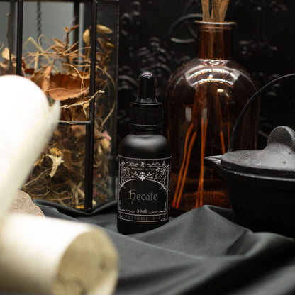 Black bottle labeled 'Hecate' with decorative elements in the background