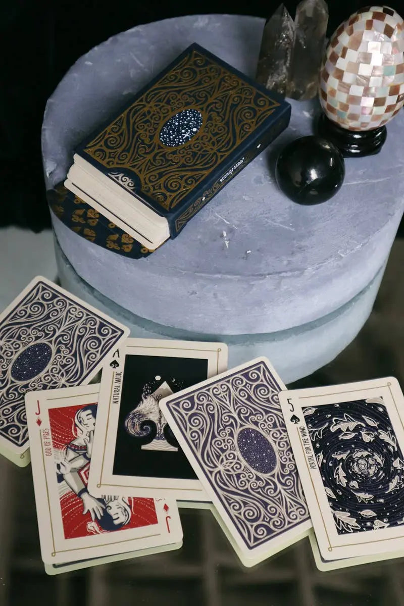 Playing cards with intricate designs on a round table