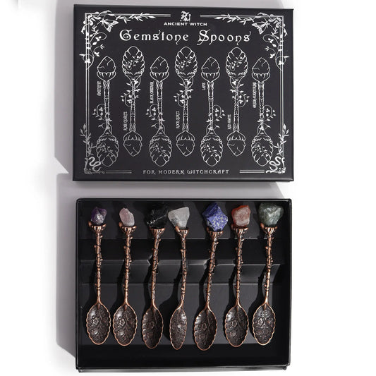 Set of gemstone spoons in a black box with decorative packaging.