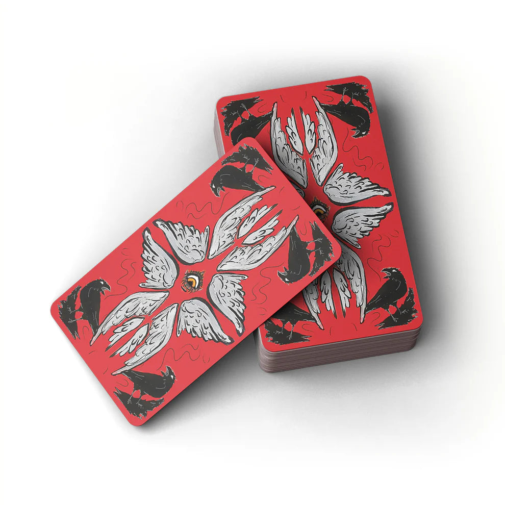 Red playing cards with black and white designs on a white background