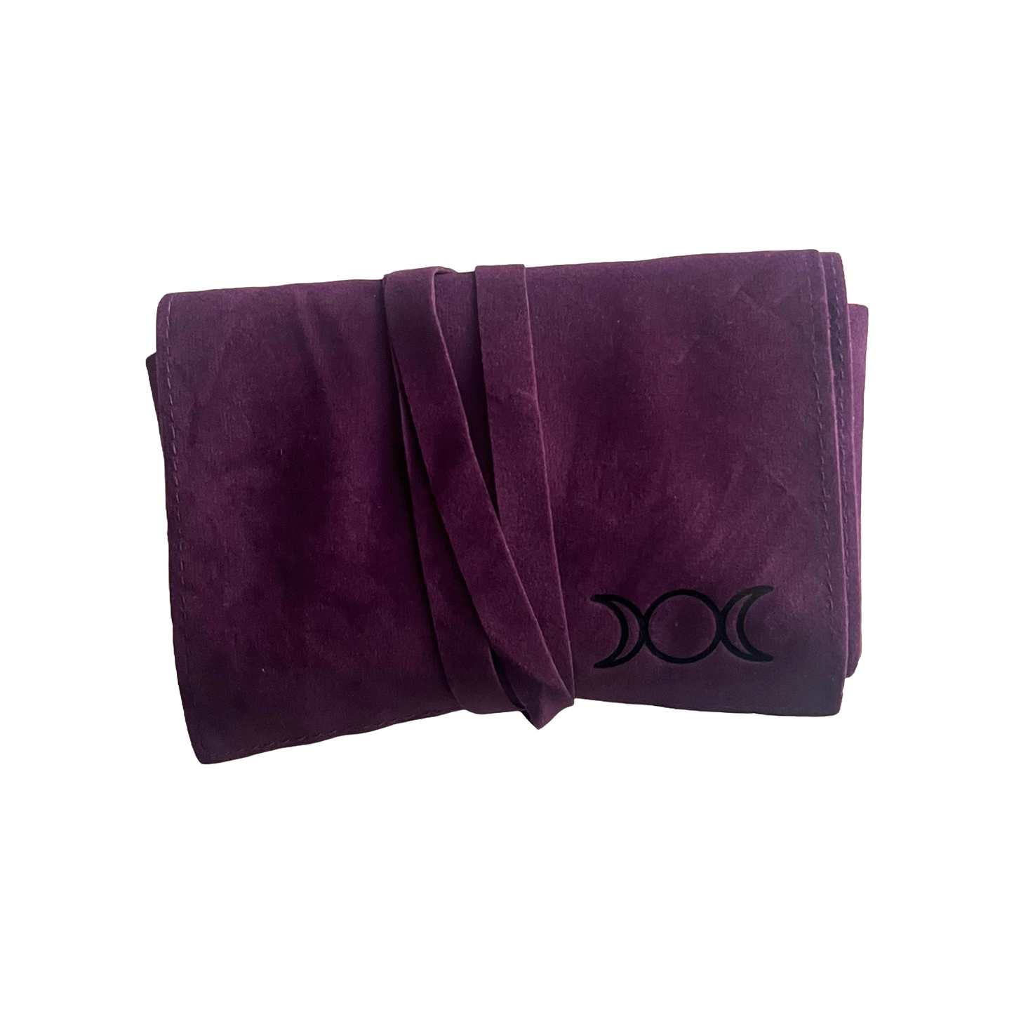 Folded purple velvet tarot pouch  with a black triple moon symbol on a white background
