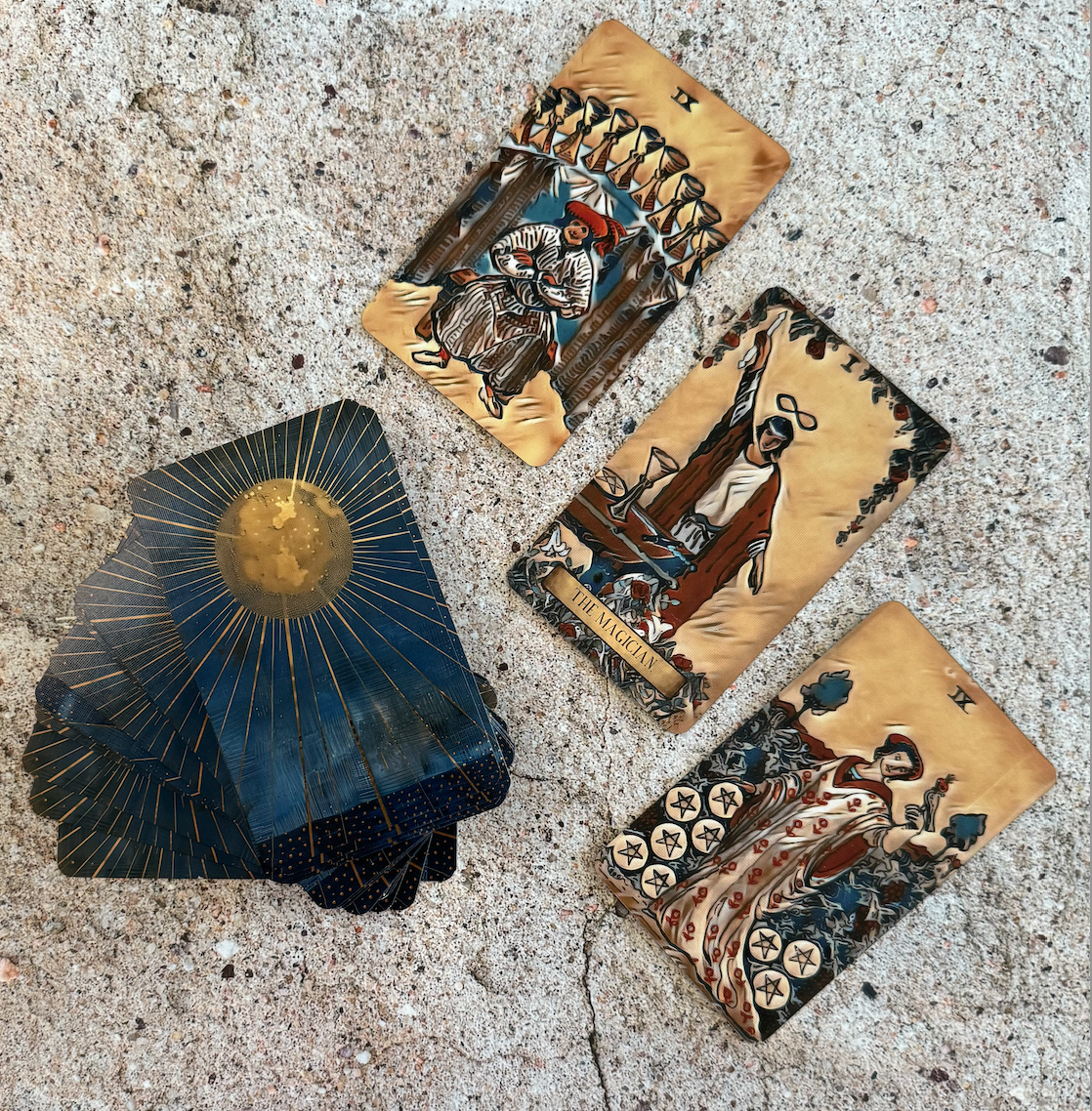 Four tarot cards with intricate designs on a textured surface