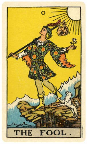 Vintage tarot card titled 'The Fool' with a person holding a goat on a yellow background.