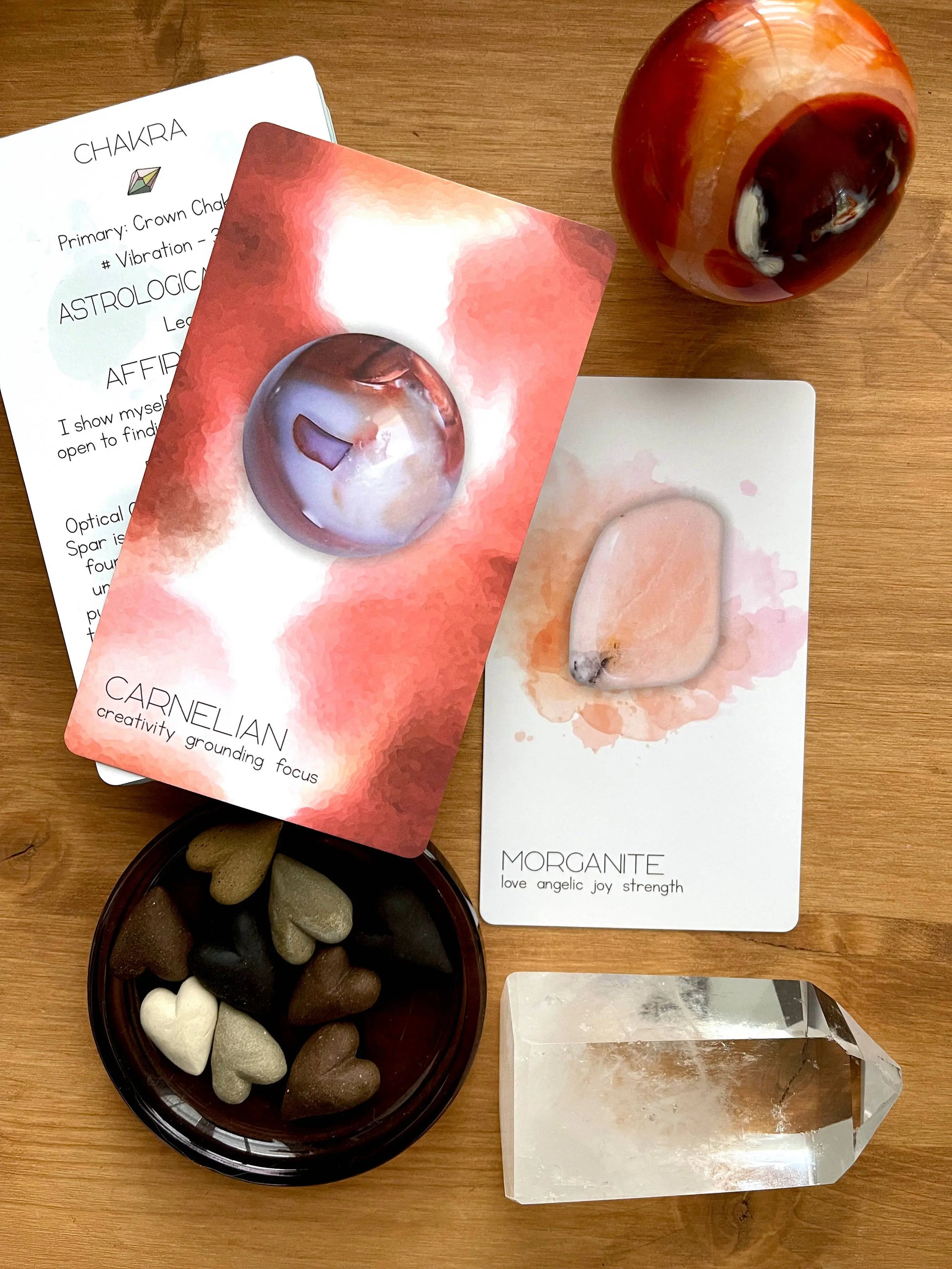 Crystal cards and stones on a wooden surface with a crystal and card in focus. radiant crystal oracle