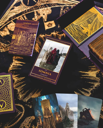 Tarot cards from 'The Somnia Tarot' with intricate designs and gold accents on a dark background.