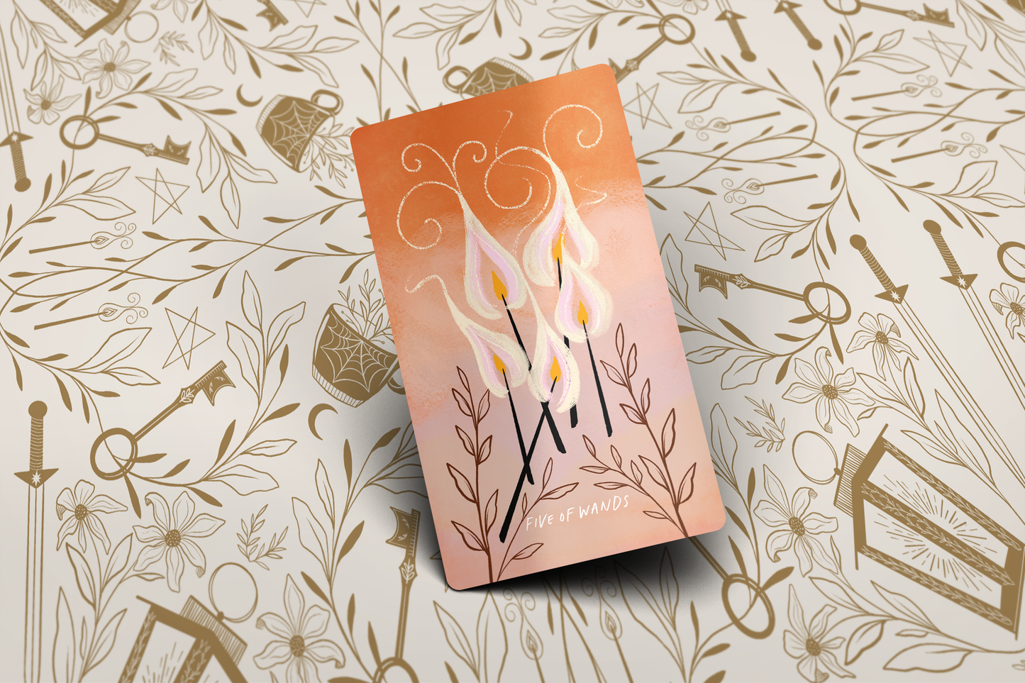 tarot card 5 of wands with decorative cover on a patterned background