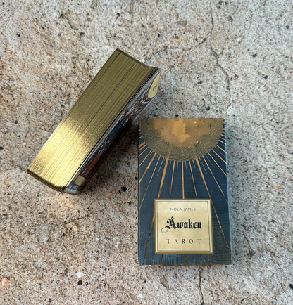 Nola James Awaken Tarot box on a textured surface
