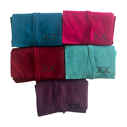 Five folded tarot pouches in blue, pink, red, green, and purple with a symbol on a white background. Oneness Emporium
