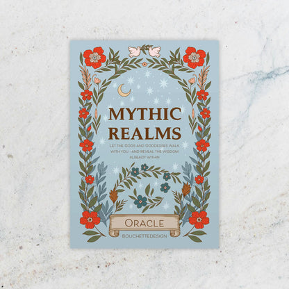 Book cover of 'Mythic Realms Oracle' with floral design on a textured surface