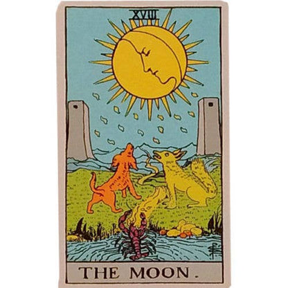 Tarot card titled 'The Moon' with a sun, two dogs, and a person in a landscape.